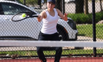 Woman playing tennis on court.