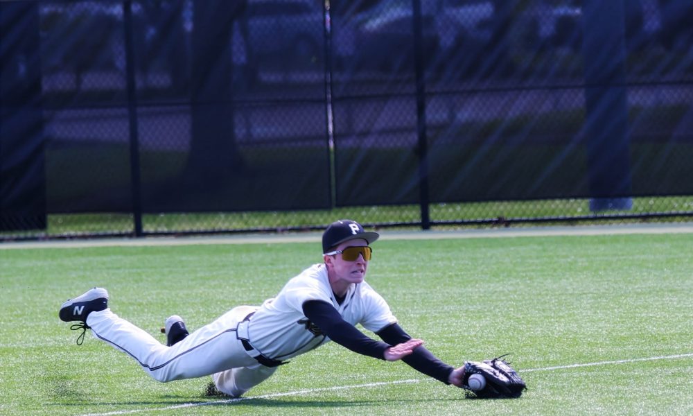 Baseball player sliding into base during game.