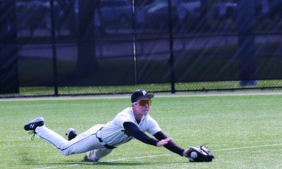 Baseball player sliding into base during game.