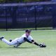 Baseball player sliding into base during game.