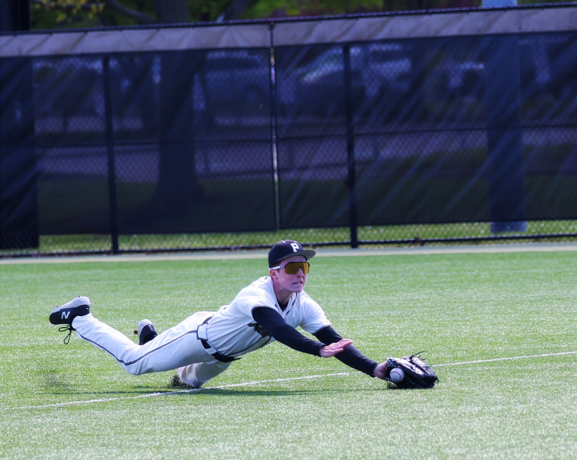 Baseball player sliding into base during game.