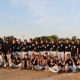 Baseball team posing for a group picture on a field.