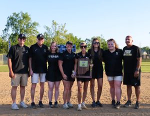 Softball coaches pose with a trophy