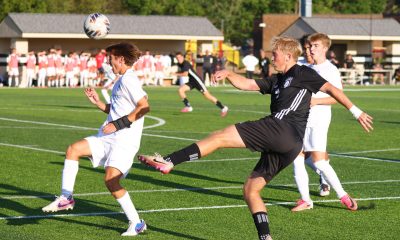 A soccer player kicks the ball.