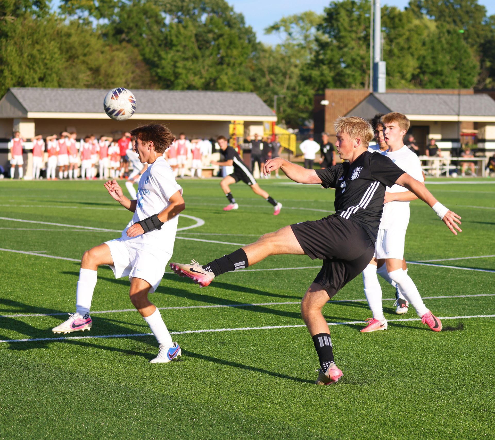 A soccer player kicks the ball.