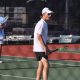 A tennis player stands on a tennis court.