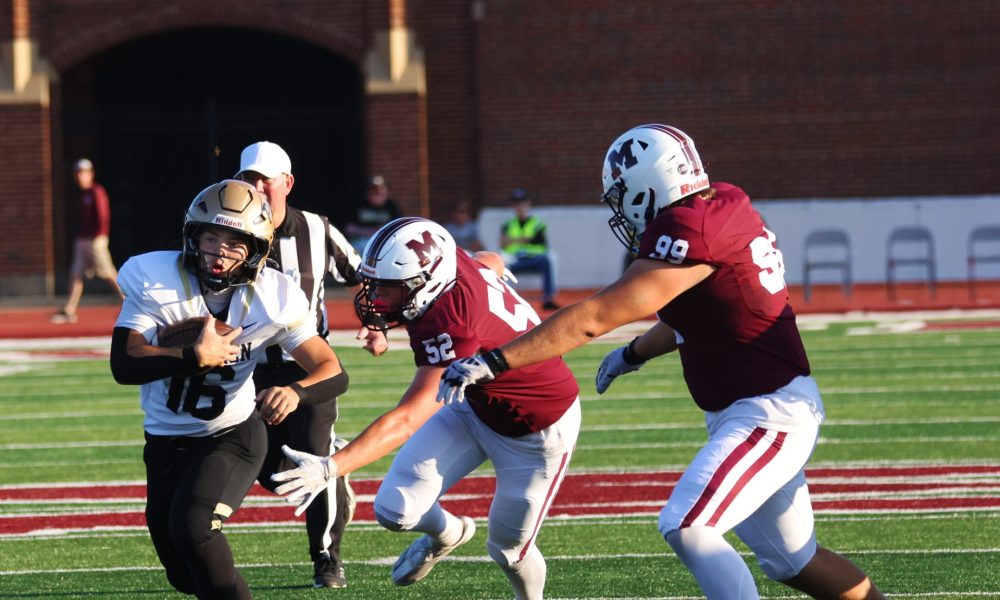 A football player runs the ball.