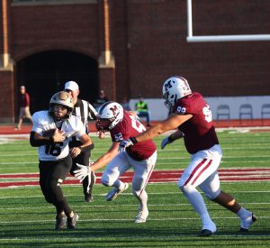 A football player runs the ball.
