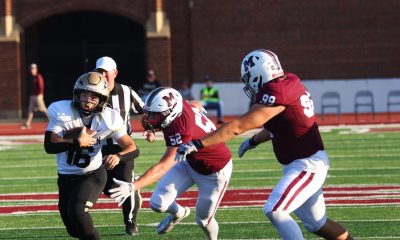 A football player runs the ball.