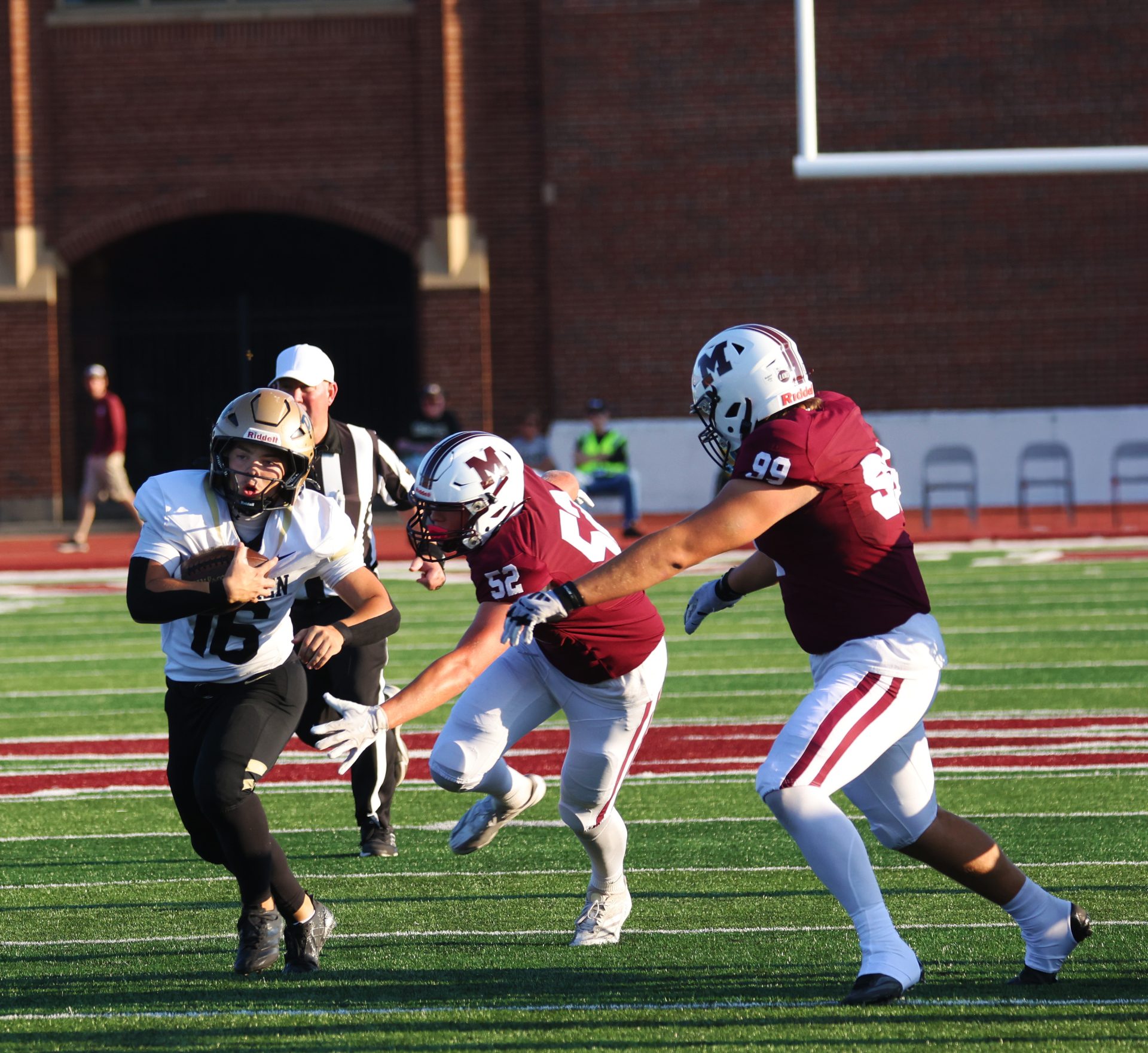 A football player runs the ball.