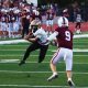 A football player runs the ball.