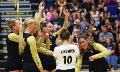 Volleyball players celebrate a point.