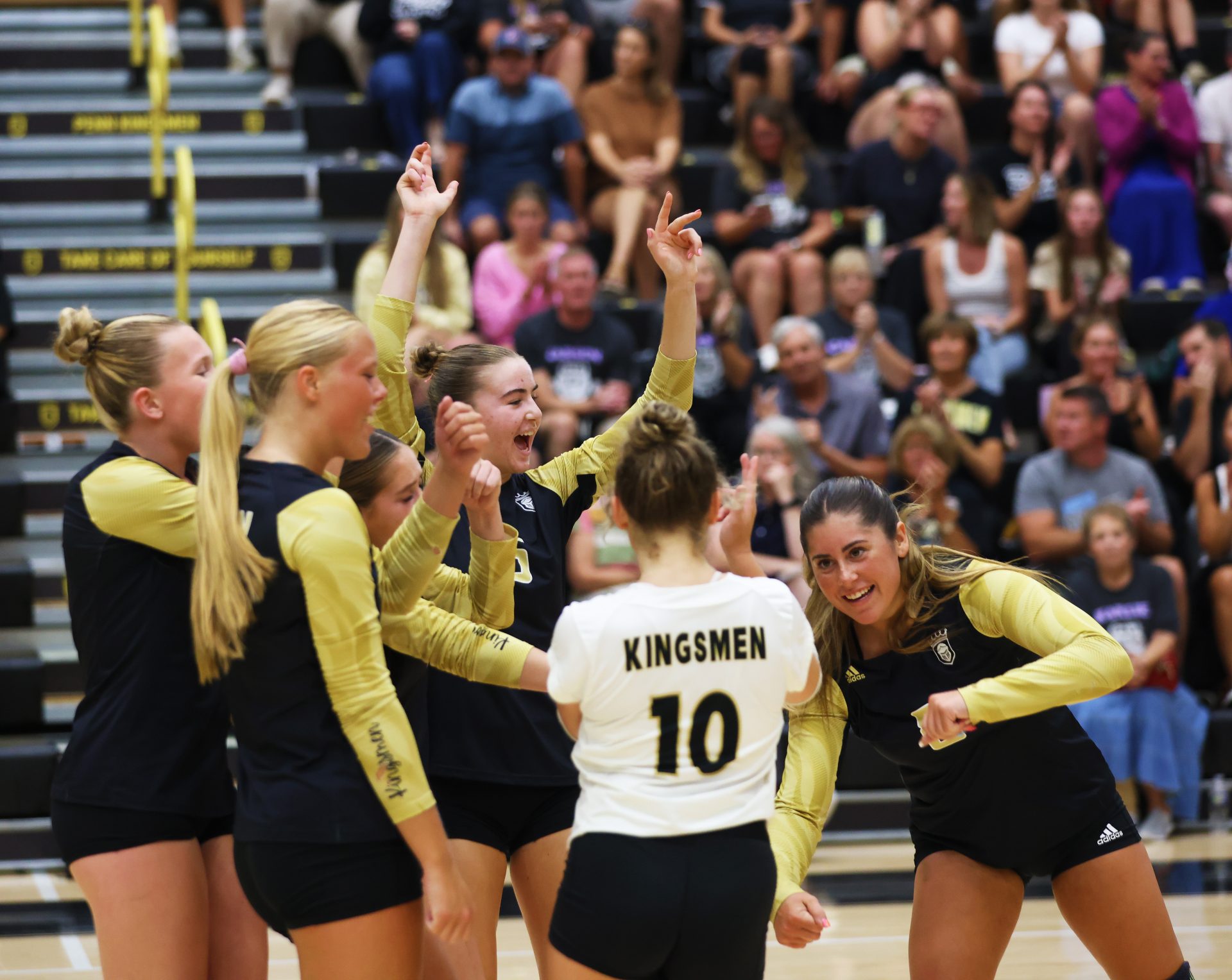 Volleyball players celebrate a point.