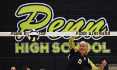 Woman playing volleyball on court.