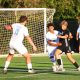 A group of men playing soccer on a field.