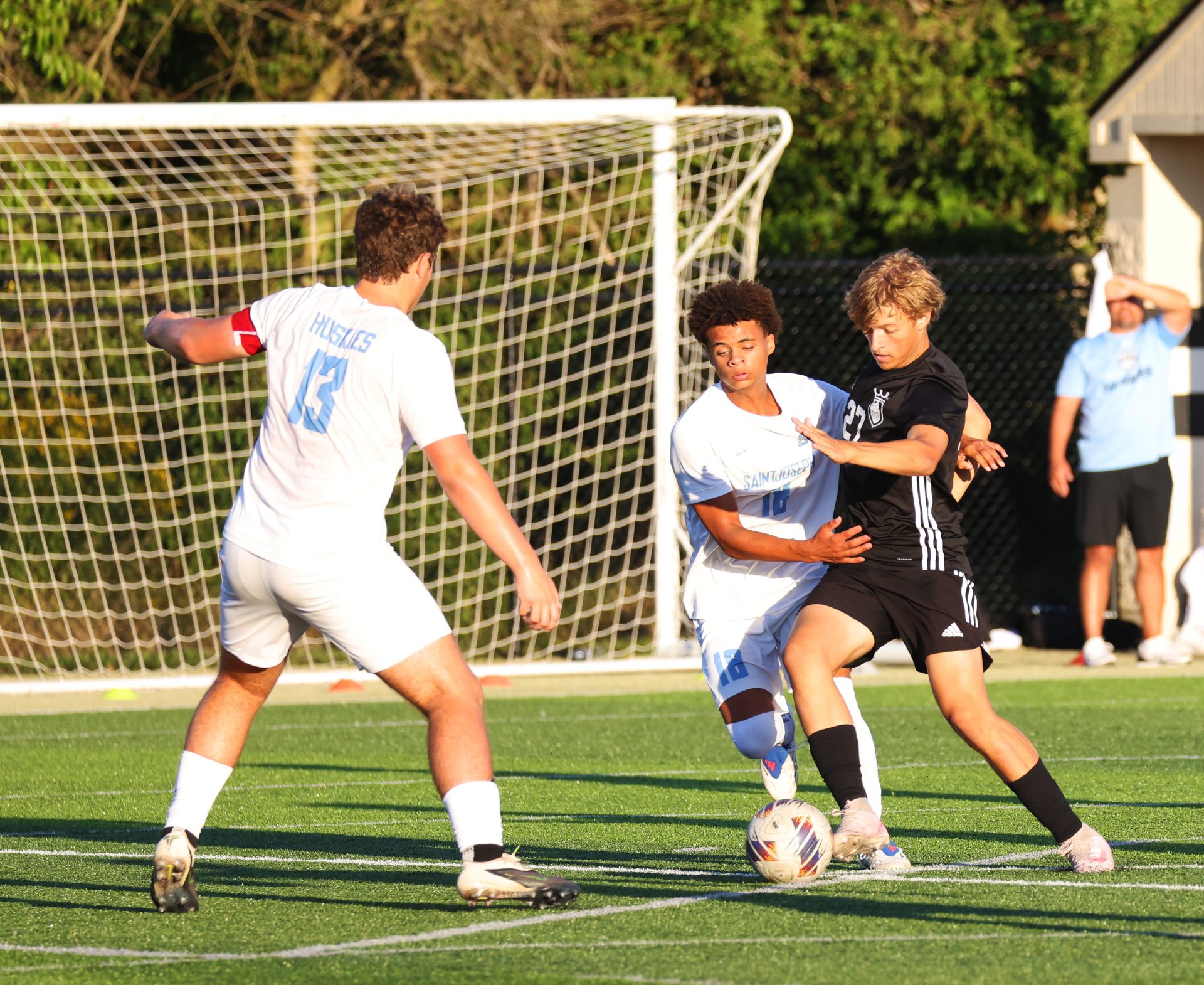 A group of men playing soccer on a field.