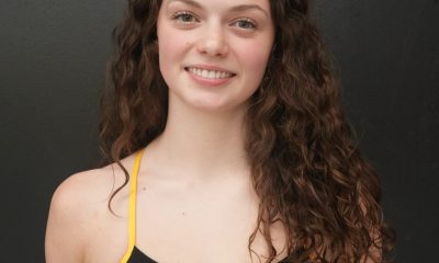 Woman in black and yellow swimsuit.