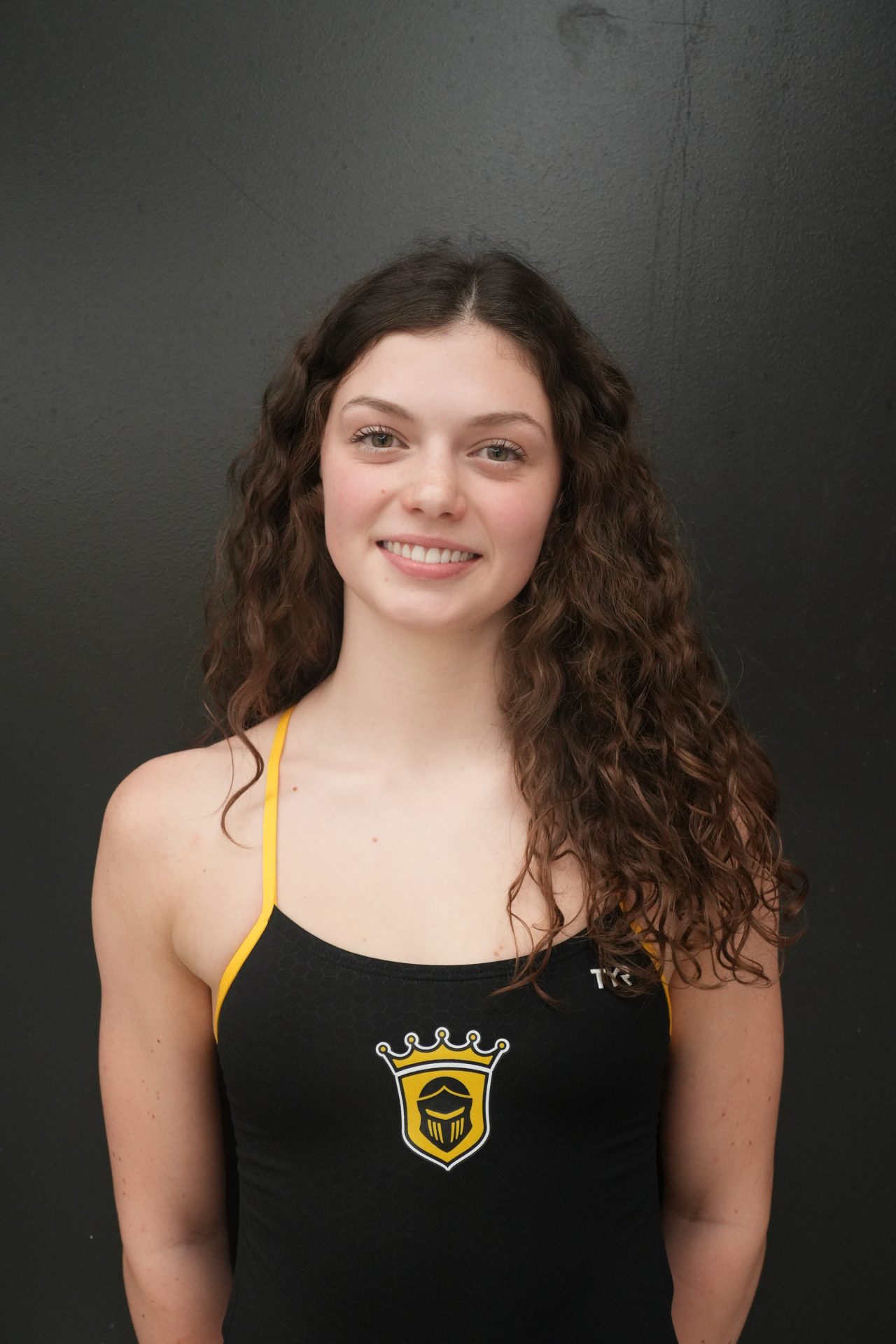 Woman in black and yellow swimsuit.