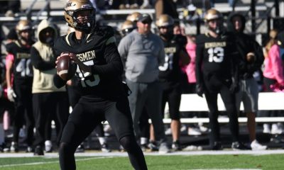 A football player throws a football.