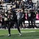 A football player throws a football.