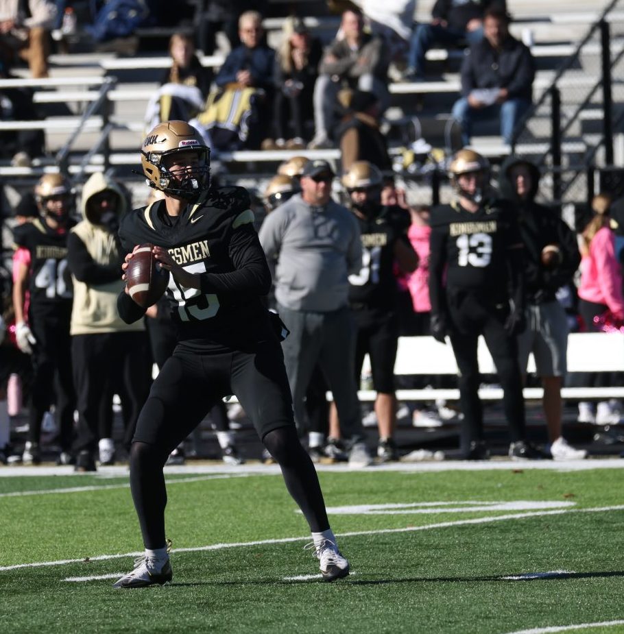 A football player throws a football.